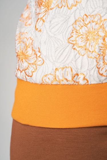 Blousonjacke "Frederike" - Weiß mit Glitzer - Orange geblümt Detailansicht von Bündchen